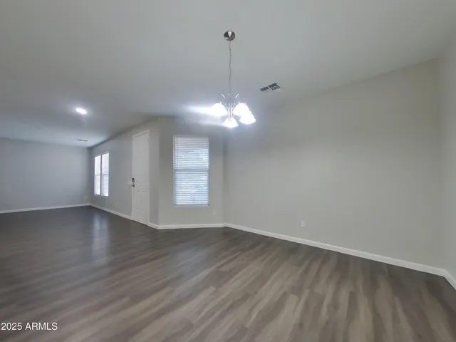 a view of a room with wooden floor and window