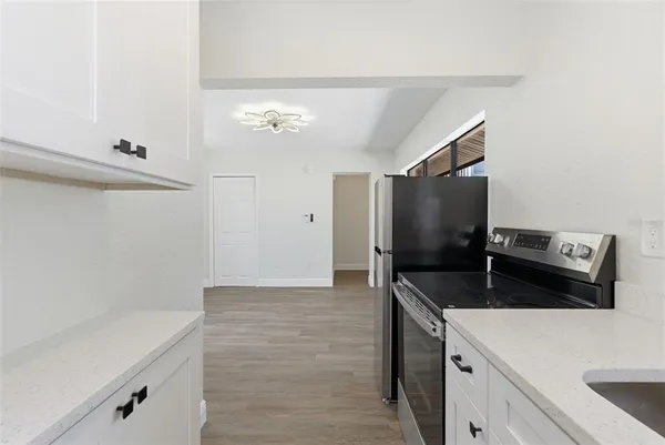 a kitchen with a sink and a refrigerator
