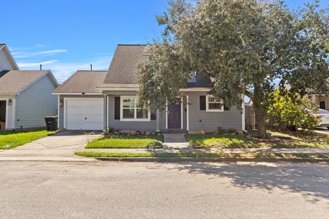 a front view of a house with a space and a street view