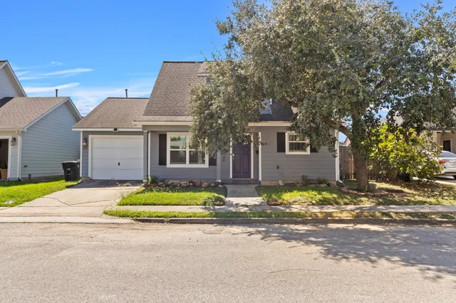 a front view of a house with a space and a street view