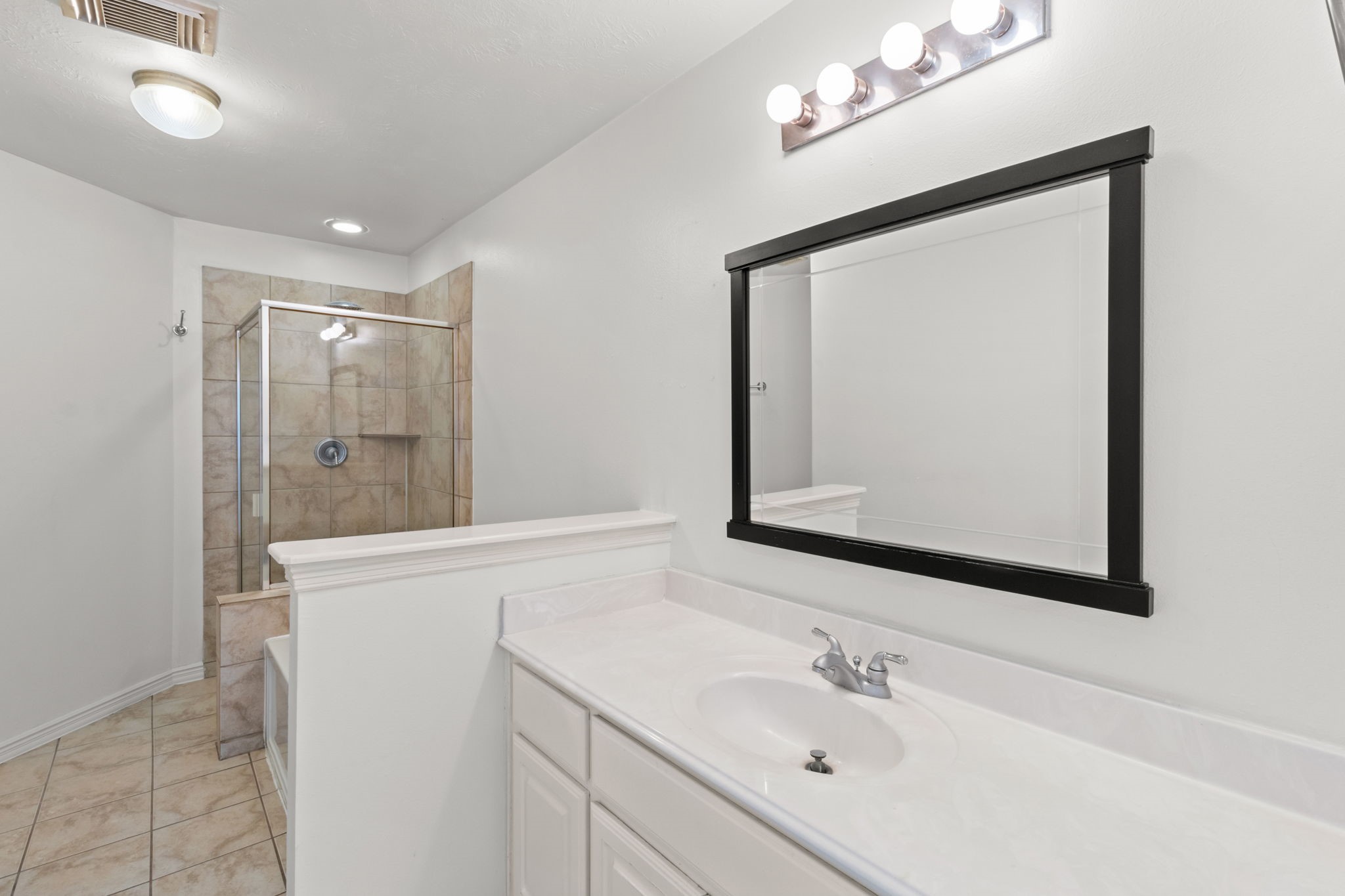 3506 Garrow Street Houston, TX 77003 - Photo 15 of 32 a bathroom with a sink vanity and a mirror