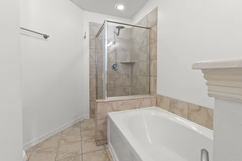 a bathroom with a bathtub and a shower