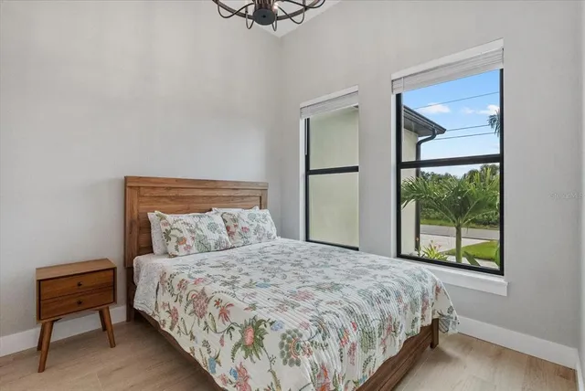 a bedroom with a bed and a night stand