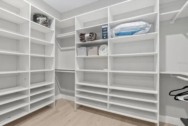 a front view of a house with a yard and palm tree