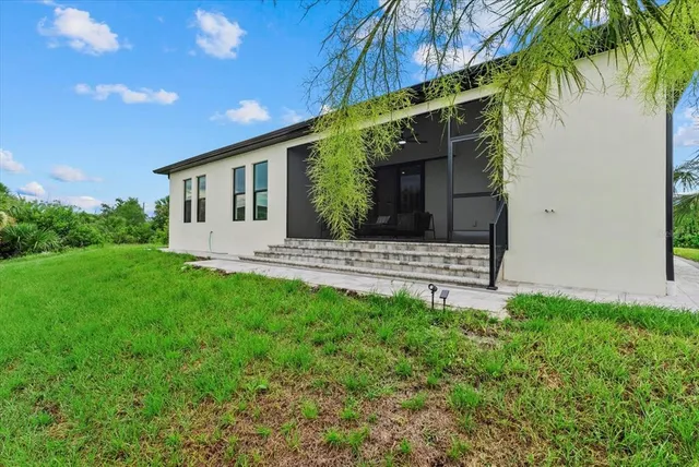 an aerial view of residential houses with outdoor space and trees