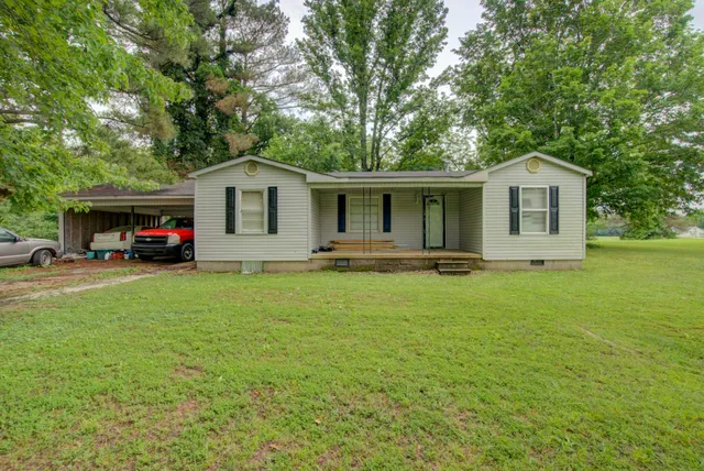 a front view of house with yard and green space
