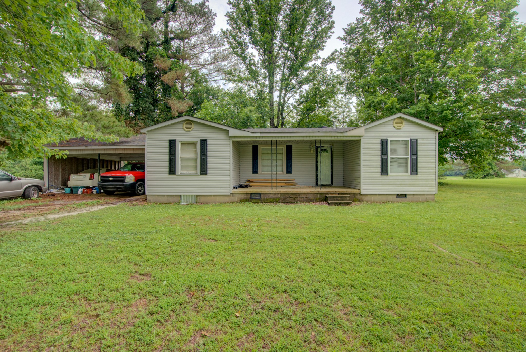 a front view of house with yard and green space