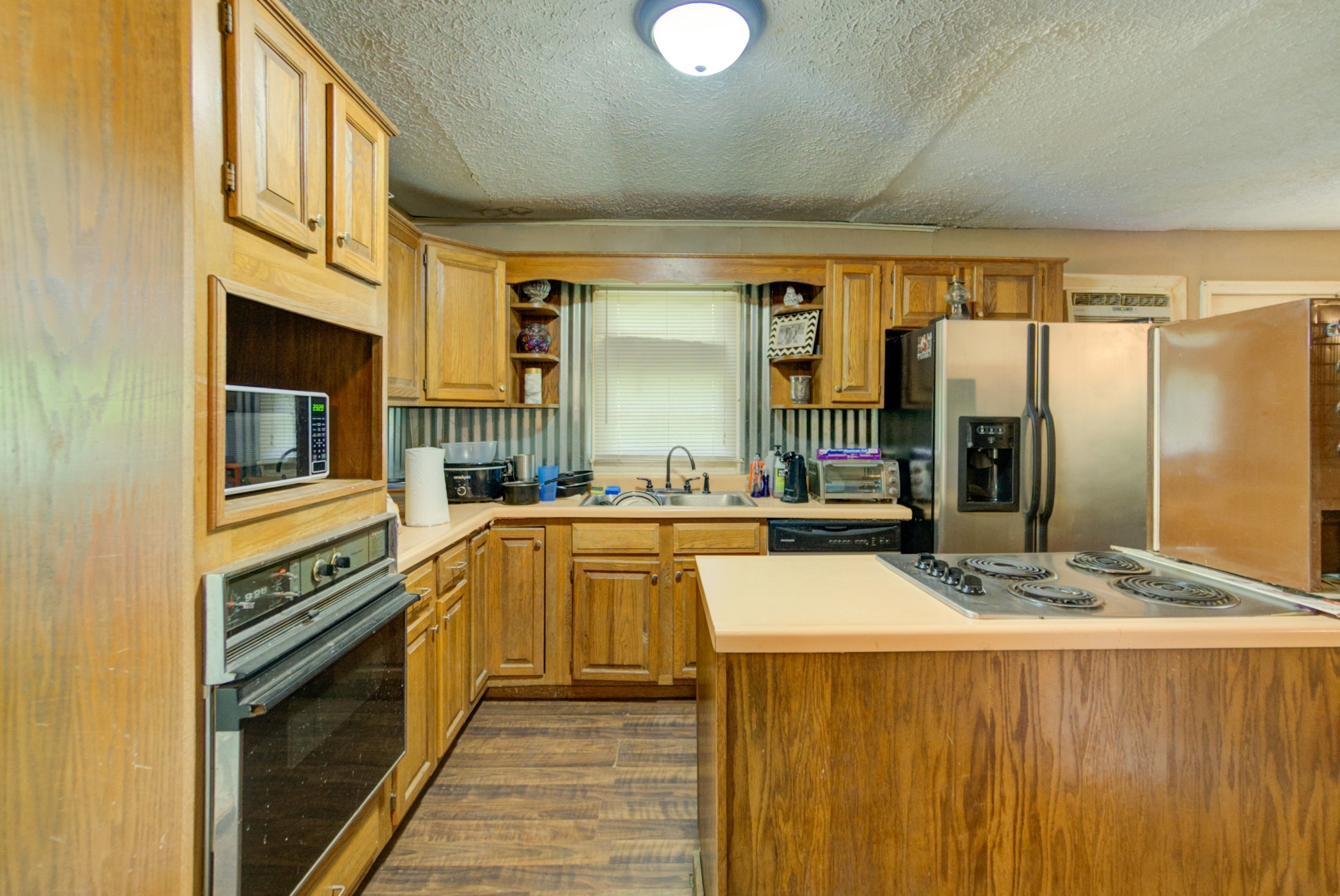 4066 Beech Bluff Road Beech Bluff, TN 38313 - Photo 4 of 14 a kitchen with stainless steel appliances granite countertop a sink and a refrigerator