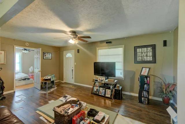 a living room with furniture and a flat screen tv