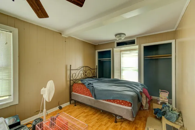 a bedroom with a bed and a window