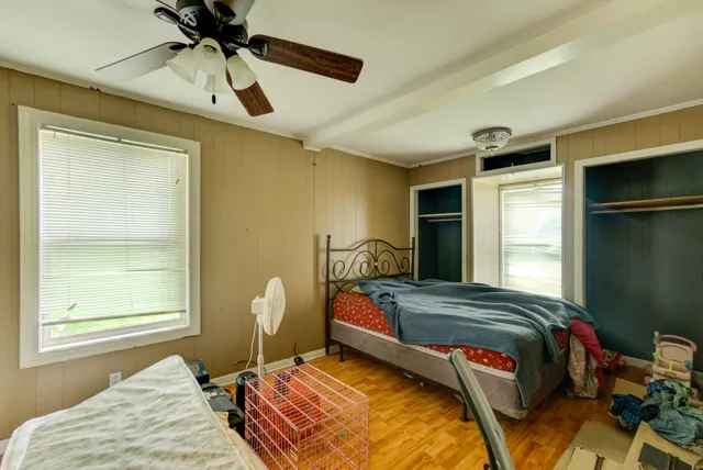 a bedroom with bed and window