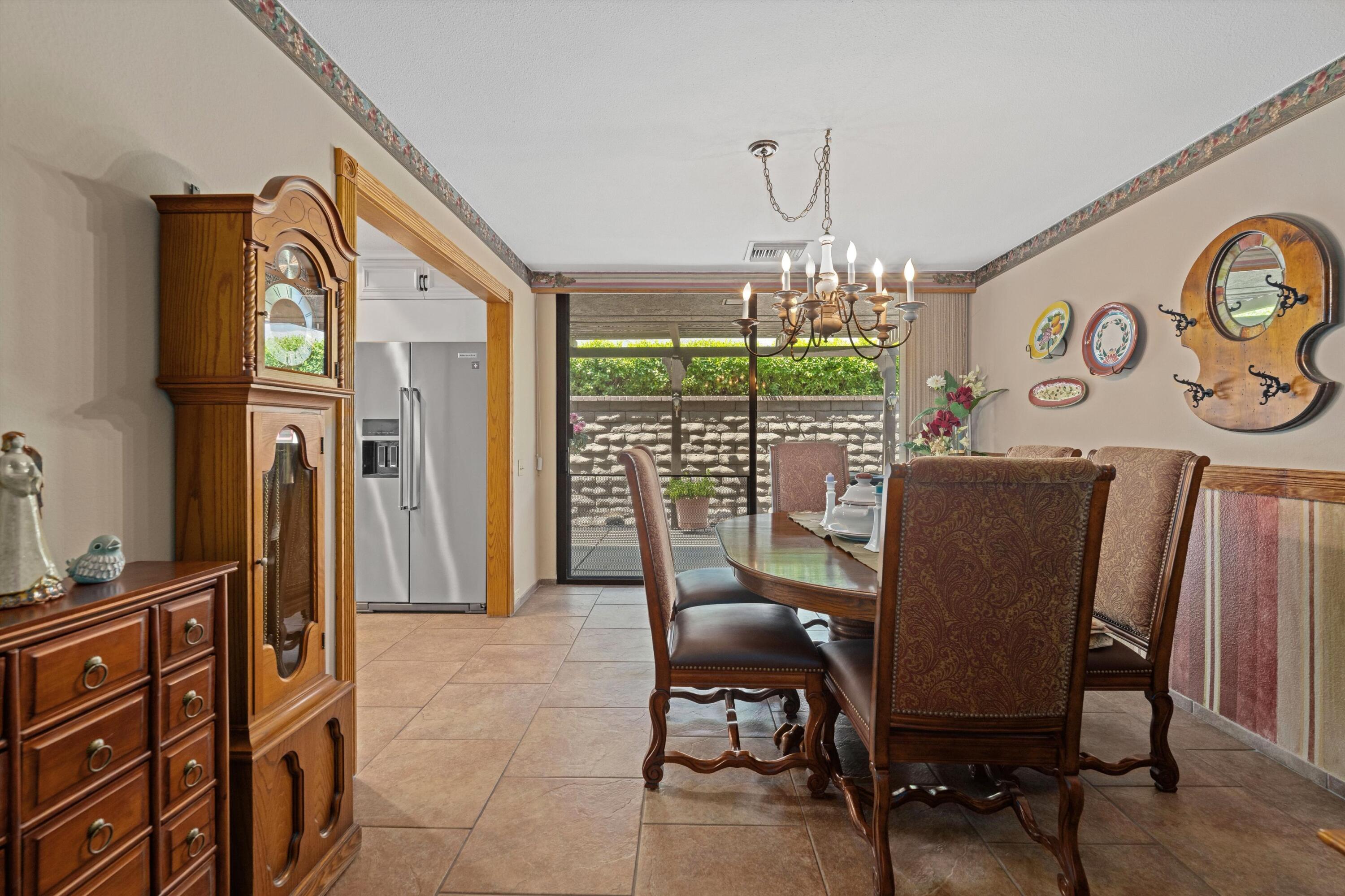 48 Cornell Drive Rancho Mirage, CA 92270 - Photo 15 of 39 a view of a dining room with furniture window and outside view