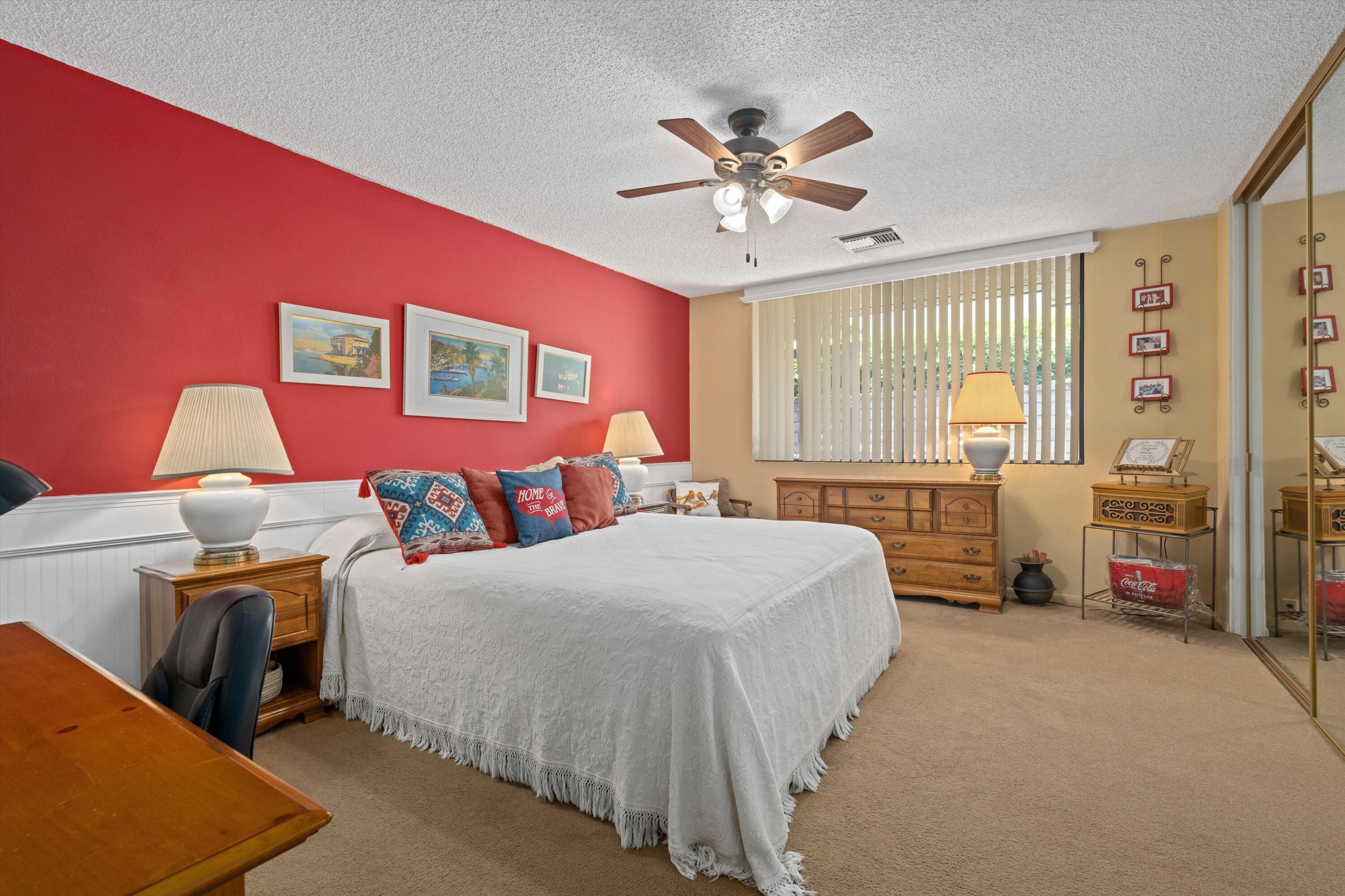 48 Cornell Drive Rancho Mirage, CA 92270 - Photo 19 of 39 a bedroom with a bed and a chandelier