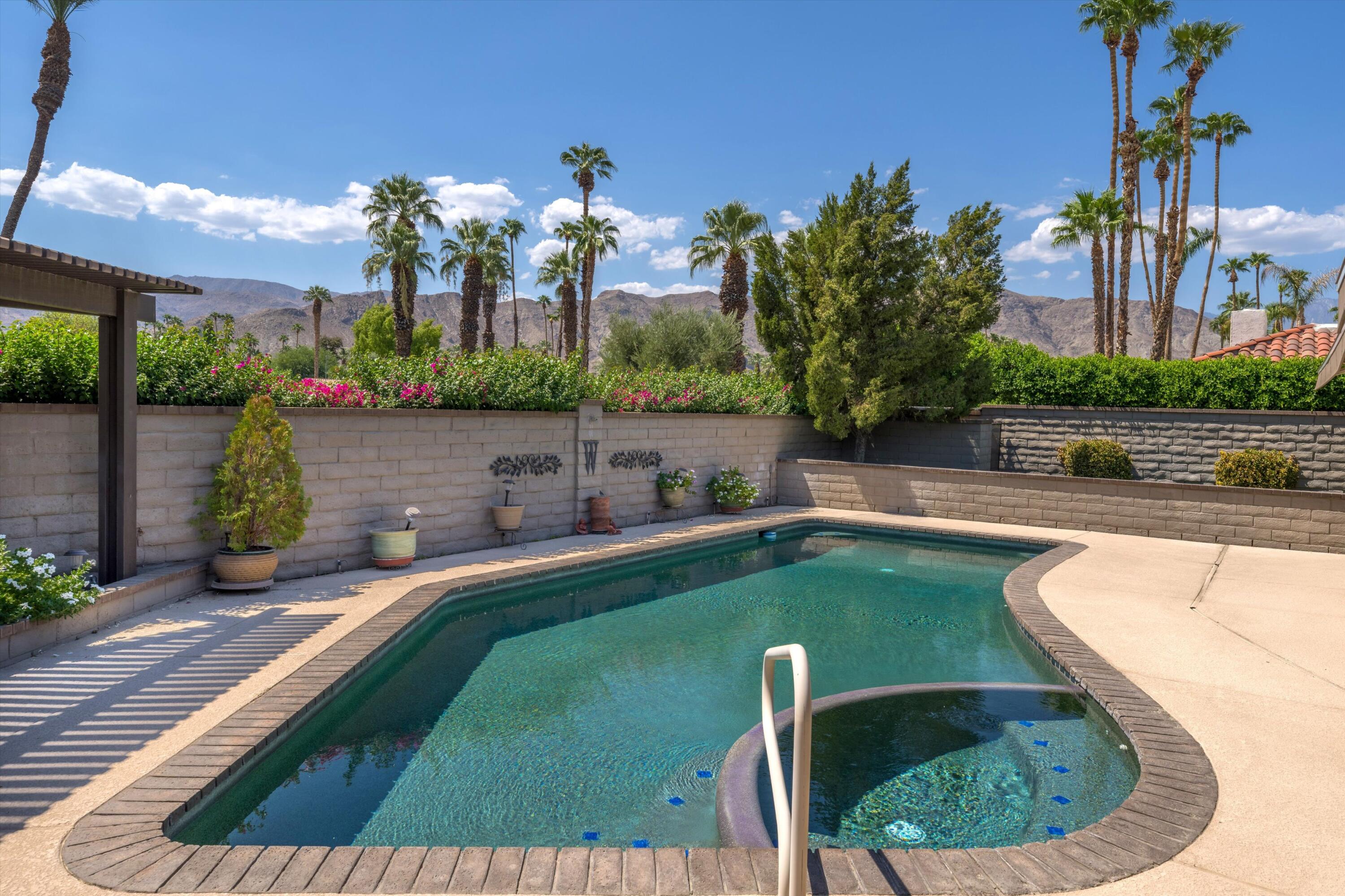 48 Cornell Drive Rancho Mirage, CA 92270 - Photo 2 of 39 a view of a swimming pool with a patio