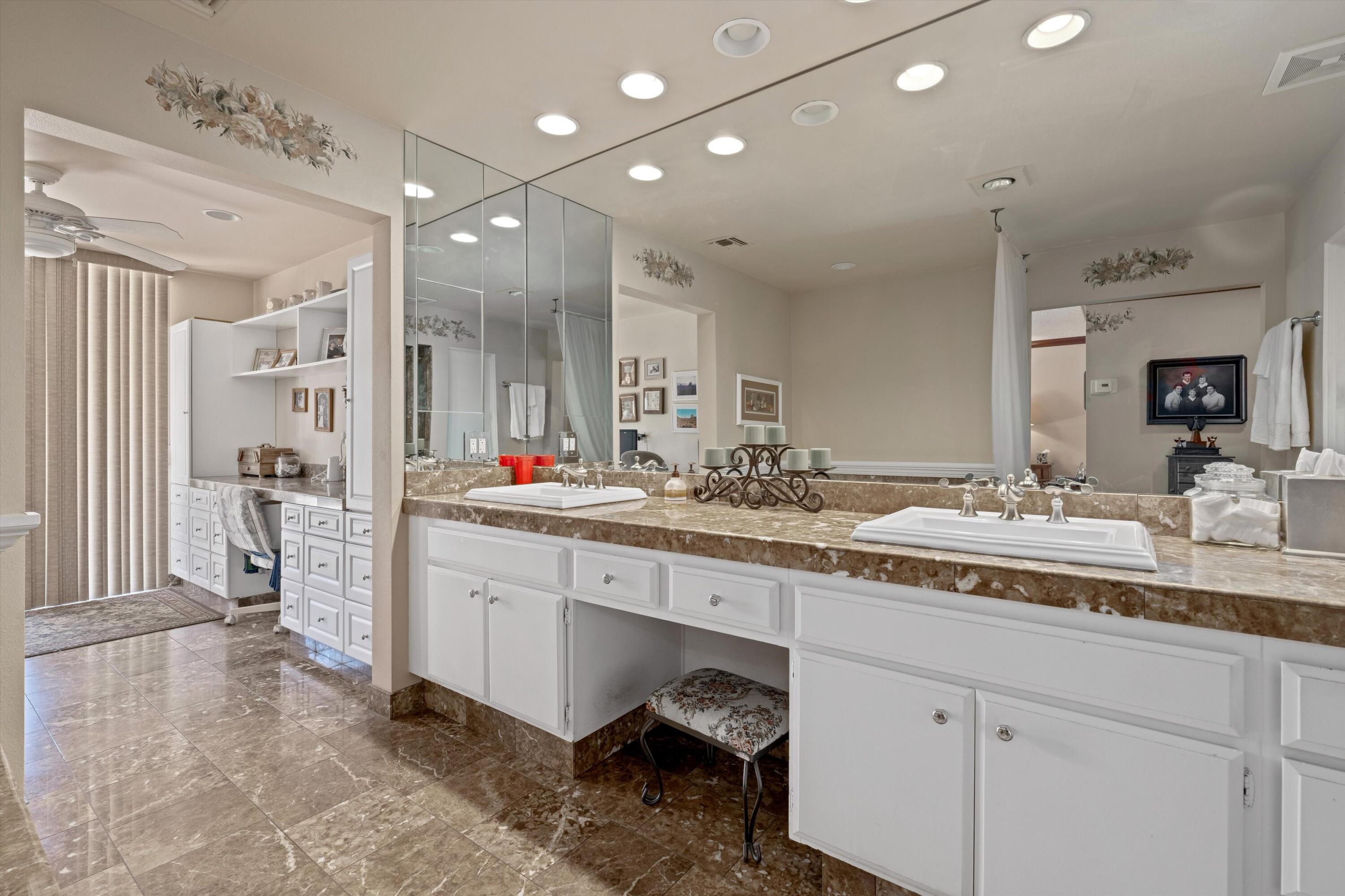 48 Cornell Drive Rancho Mirage, CA 92270 - Photo 20 of 39 a spacious bathroom with a granite countertop sink mirror and shower