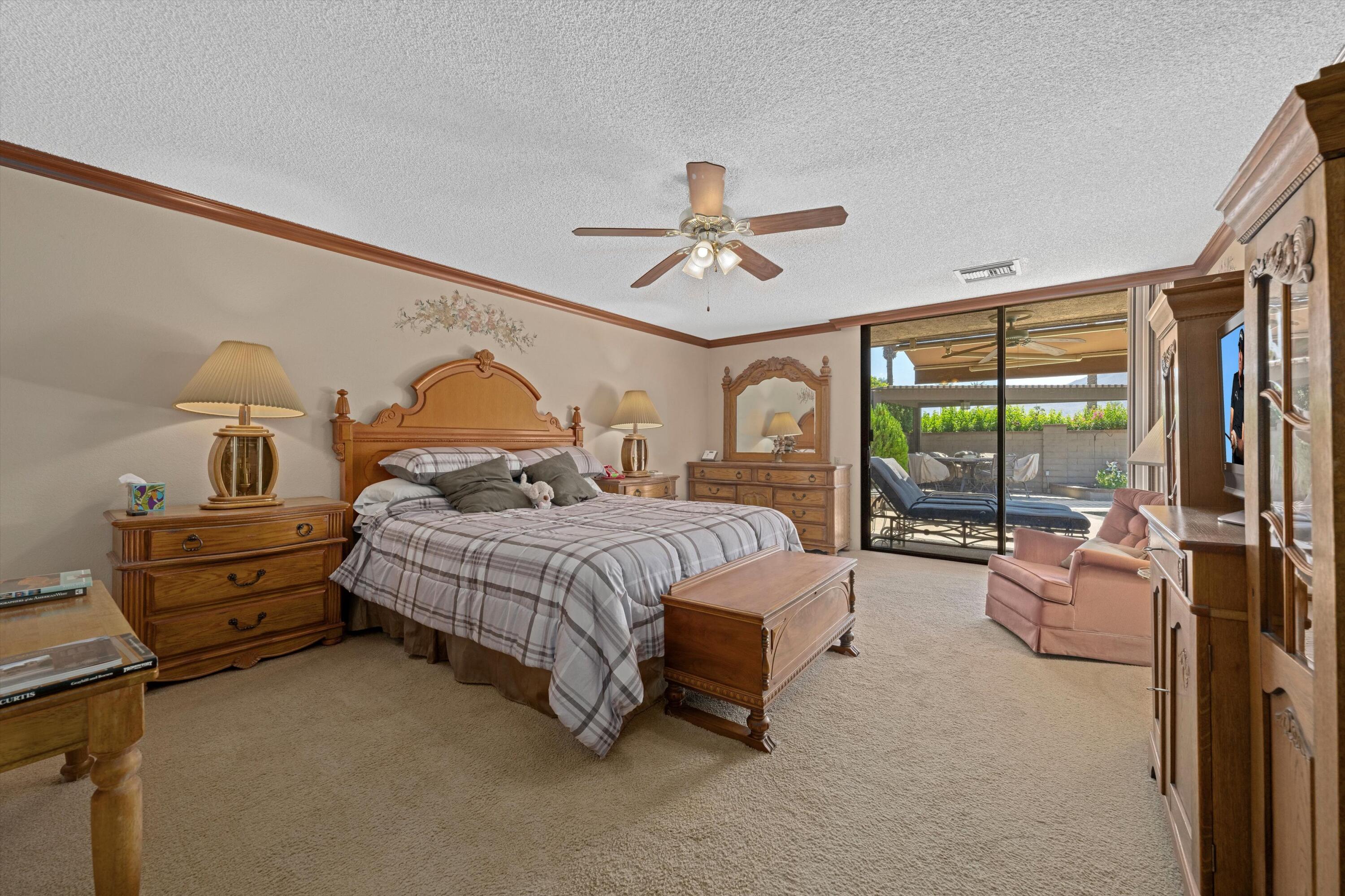 48 Cornell Drive Rancho Mirage, CA 92270 - Photo 23 of 39 a bedroom with furniture and large windows