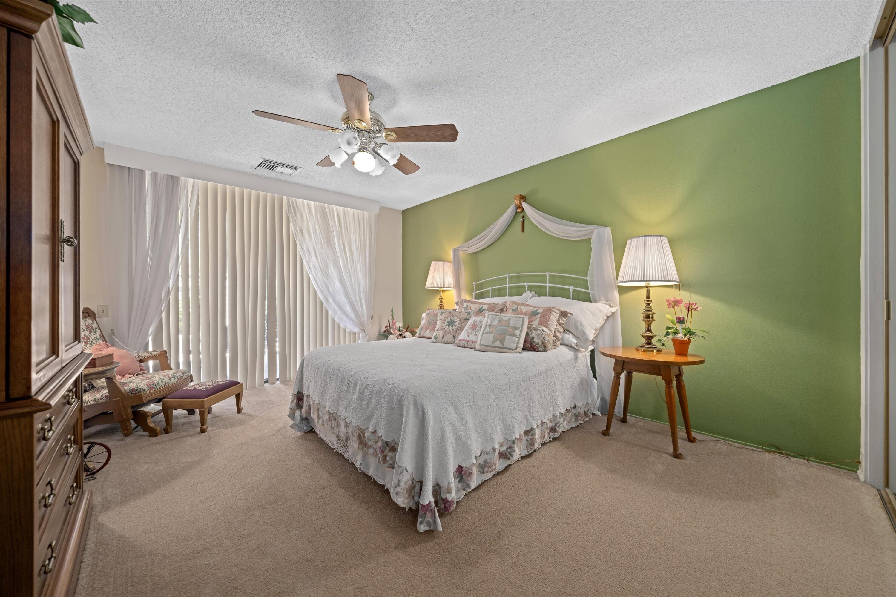 48 Cornell Drive Rancho Mirage, CA 92270 - Photo 26 of 39 a bedroom with a bed and a chandelier