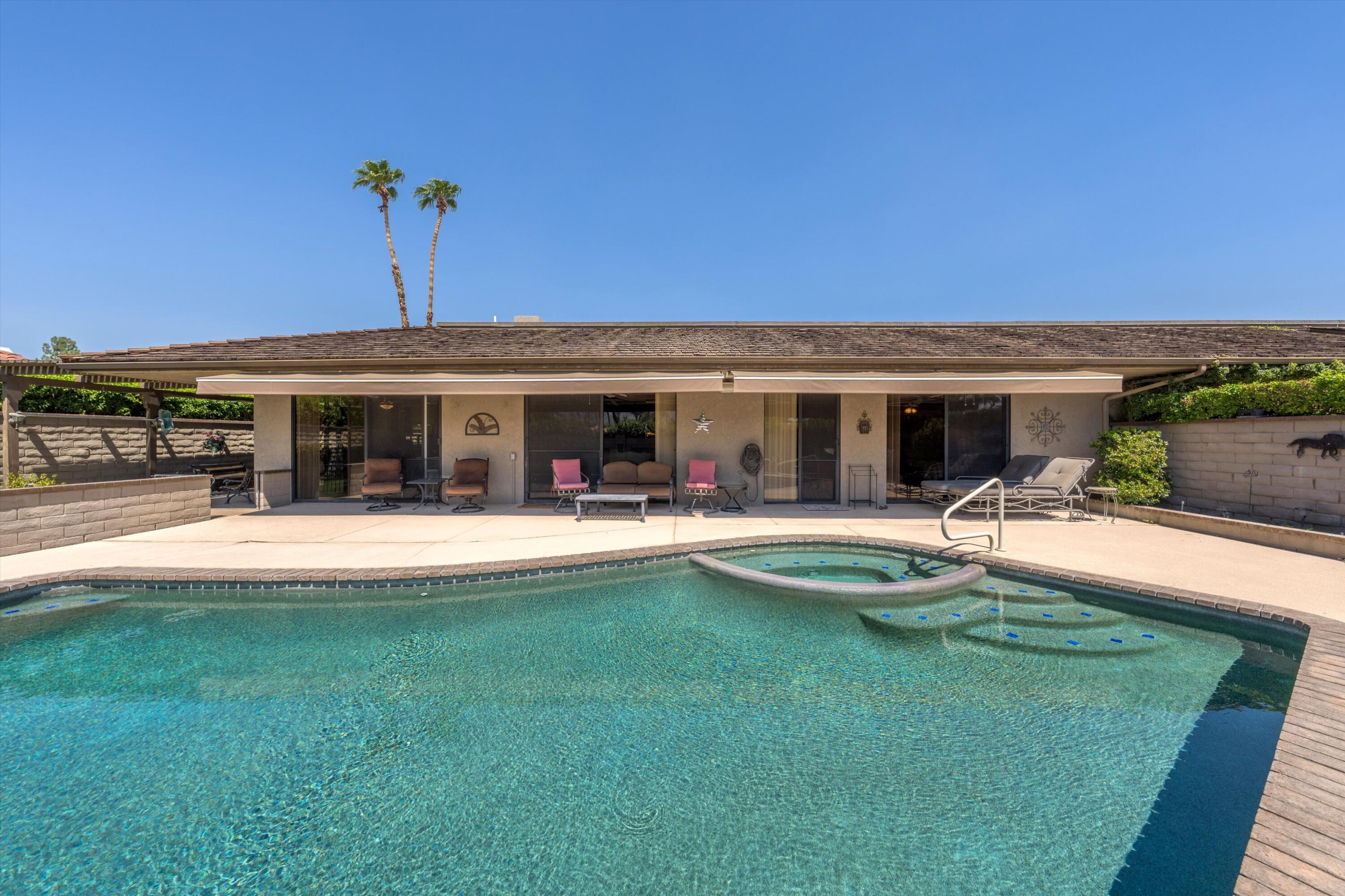 48 Cornell Drive Rancho Mirage, CA 92270 - Photo 32 of 39 a view of a house with swimming pool and a yard