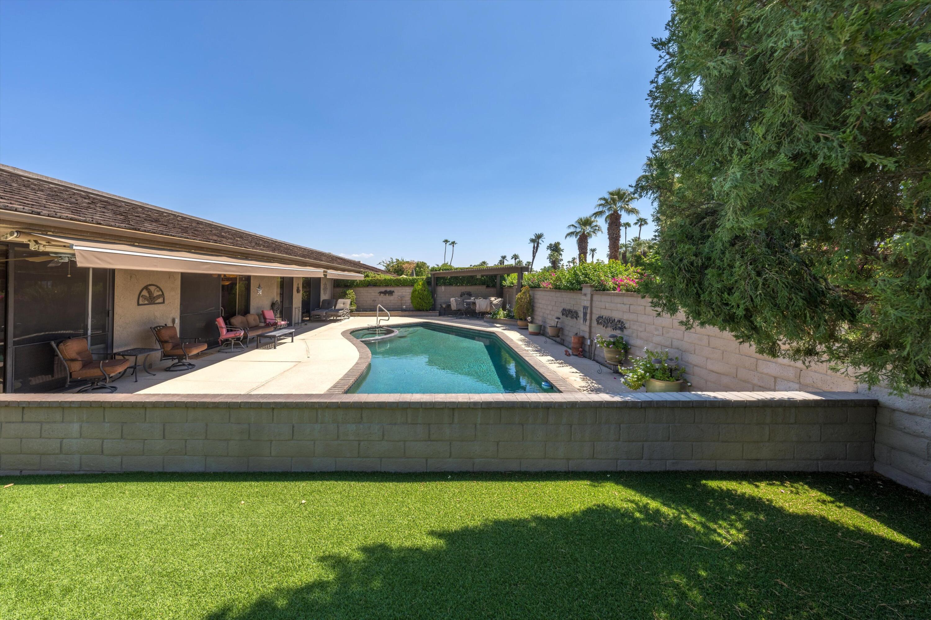 48 Cornell Drive Rancho Mirage, CA 92270 - Photo 33 of 39 a view of a house with swimming pool and sitting area