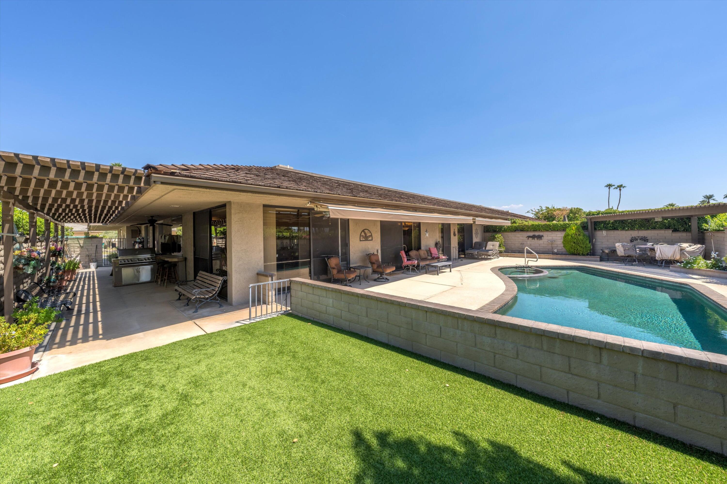 48 Cornell Drive Rancho Mirage, CA 92270 - Photo 34 of 39 a view of a house with a backyard patio and swimming pool