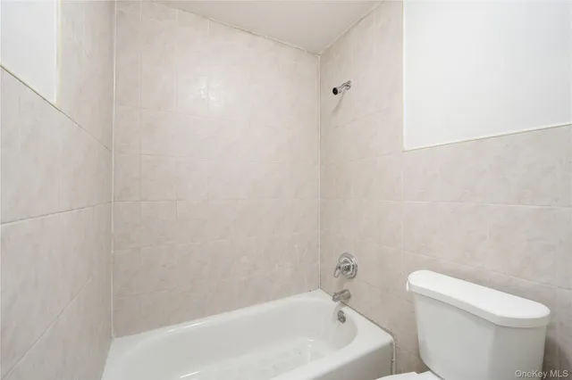 a white bath tub sitting next to a white toilet