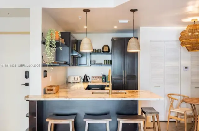 a kitchen with stainless steel appliances a sink and a table
