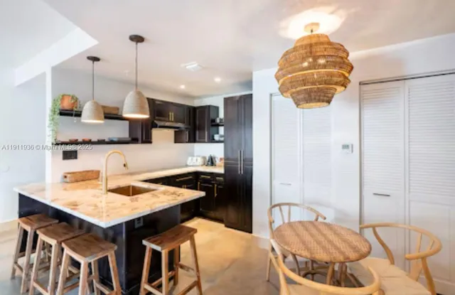 a kitchen with a table and chairs in it