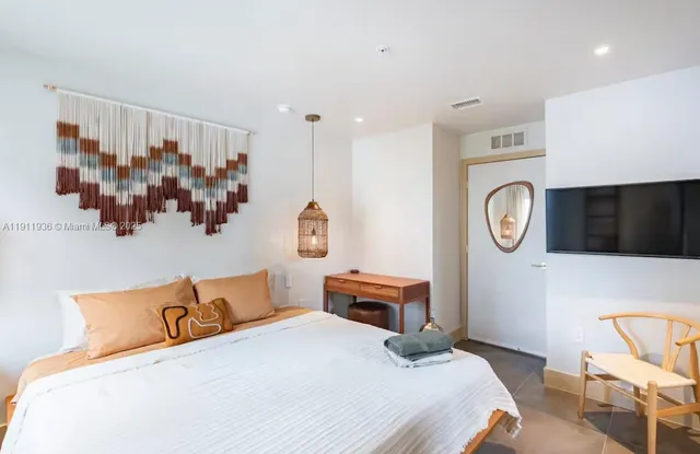 a bedroom with a bed and a cabinets