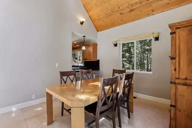 a view of a dining room with furniture and window