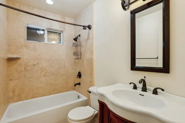 a bathroom with a sink toilet and bathtub