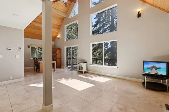 a living room with furniture a window and a flat screen tv