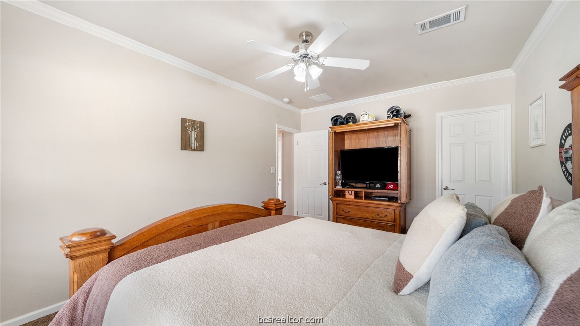 115 Cedar Lane Somerville, TX 77879 - Photo 19 of 50 a bedroom with a bed and a flat screen tv