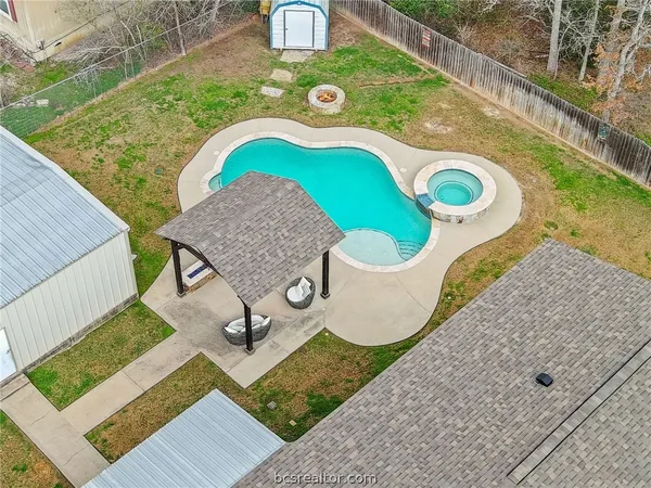 a kitchen with stainless steel appliances kitchen island granite countertop a stove a sink a refrigerator white cabinets and wooden floor