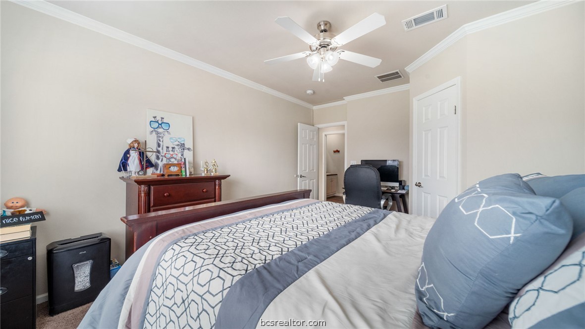 115 Cedar Lane Somerville, TX 77879 - Photo 23 of 50 a bedroom with a bed and a chandelier