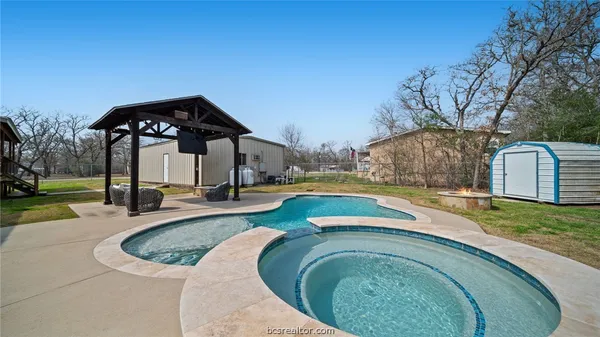 a view of a swimming pool with a patio
