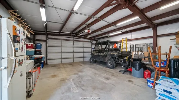 a view of a backyard with table and chairs under an umbrella