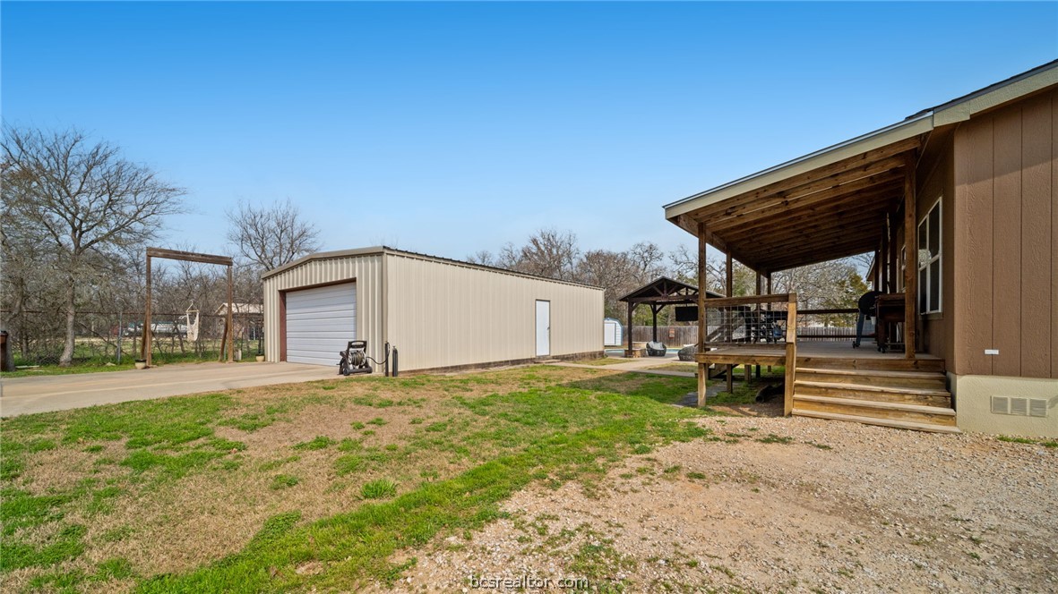115 Cedar Lane Somerville, TX 77879 - Photo 35 of 50 a view of a backyard with table and chairs under an umbrella