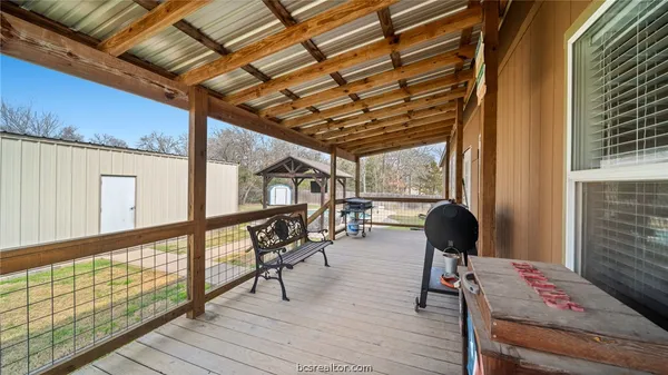 a view of house with backyard and deck