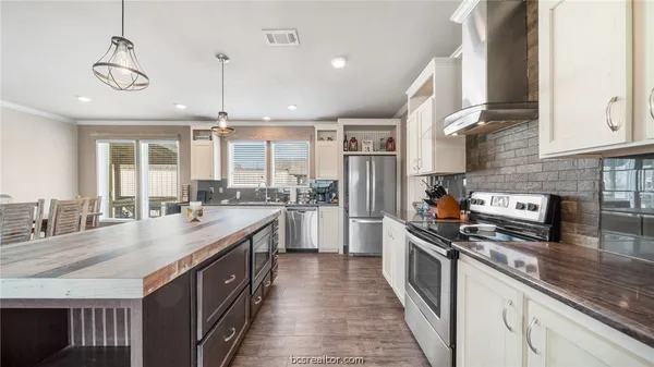 a kitchen with granite countertop a sink counter top space appliances and cabinets