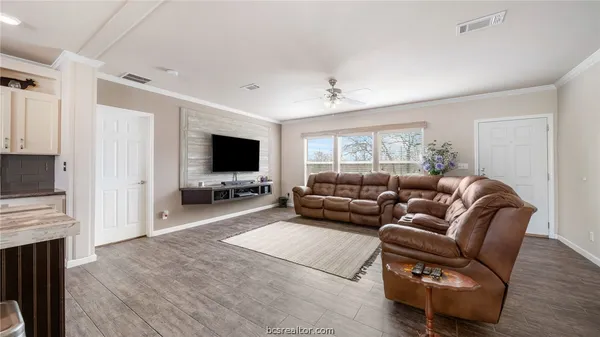 a bathroom with a granite countertop sink a toilet a mirror and shower