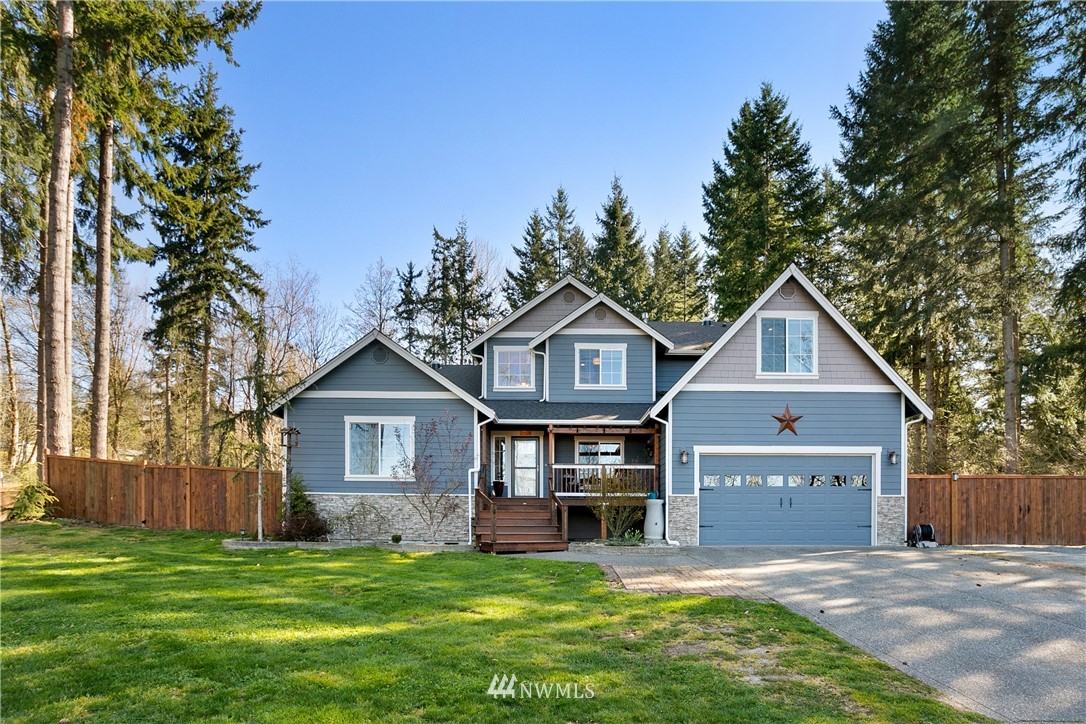 27515 Rose Road Arlington, WA 98223 - Photo 1 of 34 a front view of a house with a yard and garage