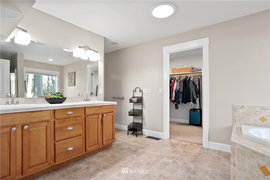 27515 Rose Road Arlington, WA 98223 - Photo 12 of 34 a spacious bathroom with a sink and a mirror
