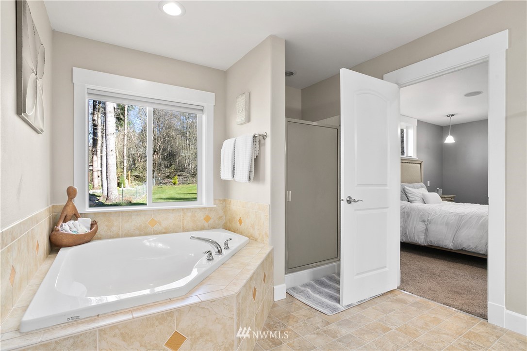27515 Rose Road Arlington, WA 98223 - Photo 13 of 34 a bathroom with a bathtub and a shower