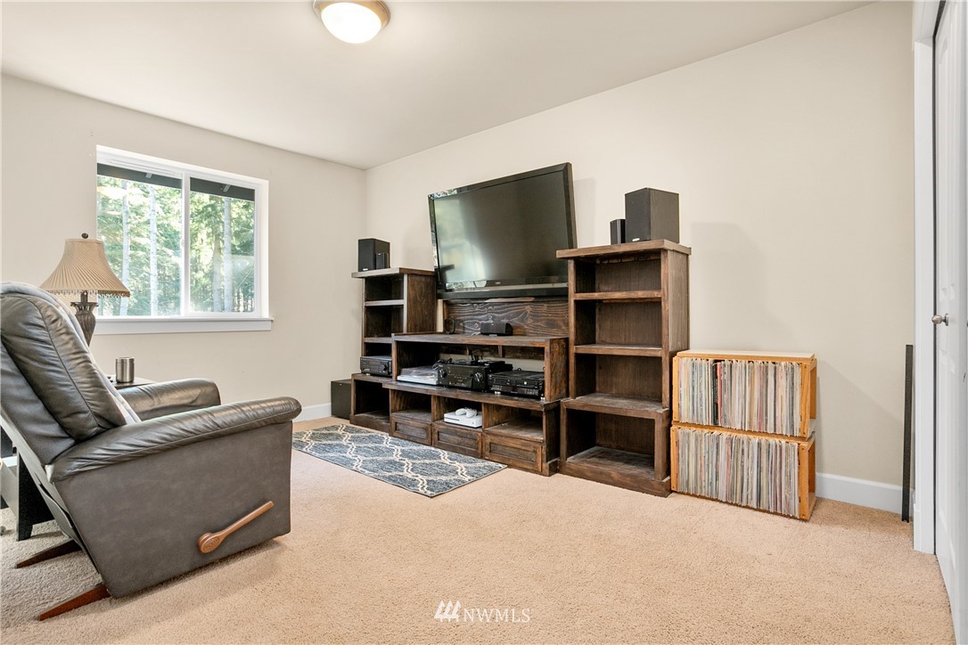 27515 Rose Road Arlington, WA 98223 - Photo 15 of 34 a living room with furniture a window and a flat screen tv