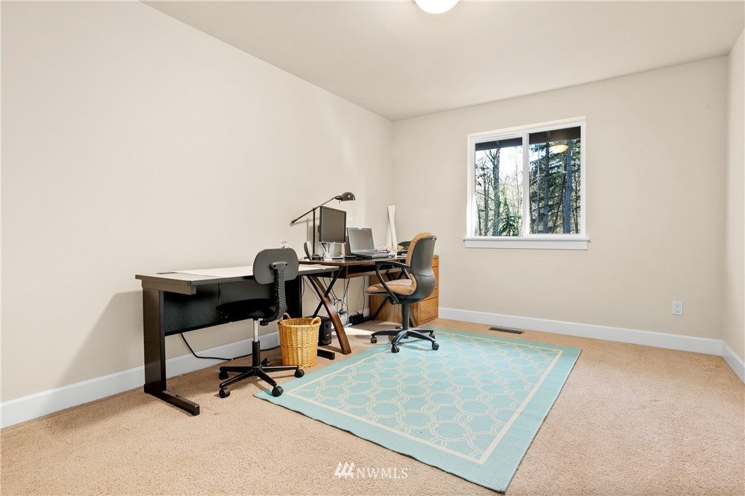 27515 Rose Road Arlington, WA 98223 - Photo 16 of 34 a view of a workspace with furniture and a window