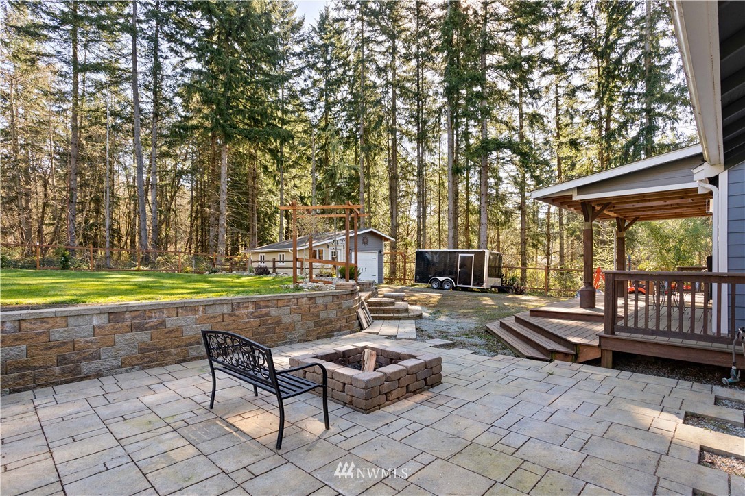 27515 Rose Road Arlington, WA 98223 - Photo 26 of 34 a view of swimming pool with chairs and trees