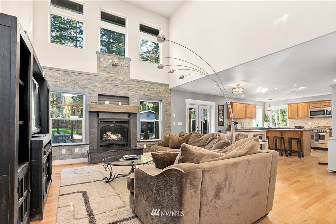 27515 Rose Road Arlington, WA 98223 - Photo 5 of 34 a living room with furniture large window and fireplace