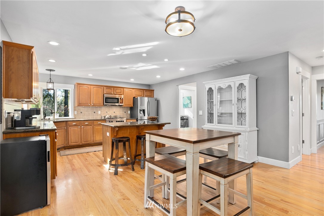 27515 Rose Road Arlington, WA 98223 - Photo 6 of 34 a dining hall with stainless steel appliances kitchen island granite countertop a dining table and chairs