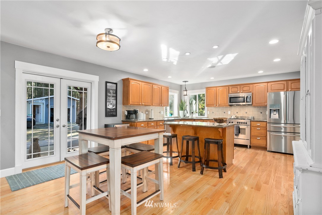 27515 Rose Road Arlington, WA 98223 - Photo 7 of 34 a large kitchen with lots of counter and chairs