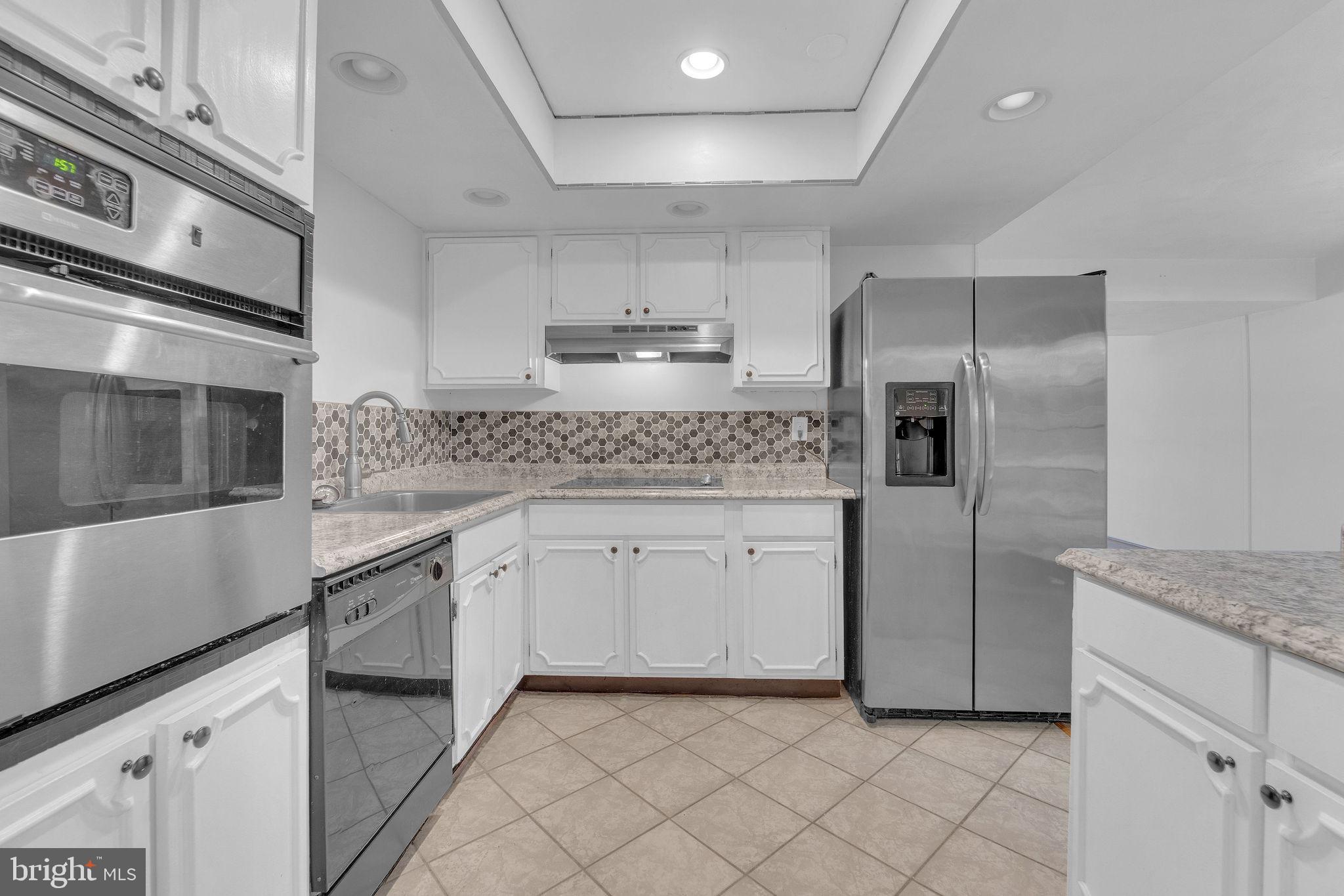 40 Rittenhouse Drive Willingboro, NJ 08046 - Photo 17 of 30 a kitchen with granite countertop white cabinets and stainless steel appliances